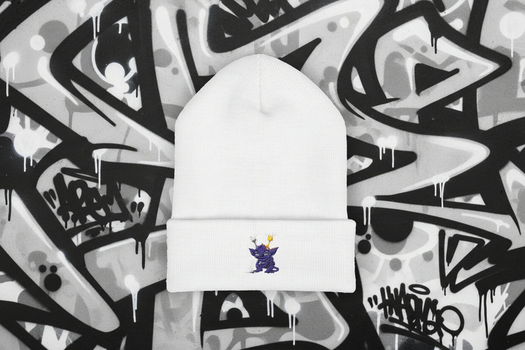 White beanie with a small embroidered design on a white background