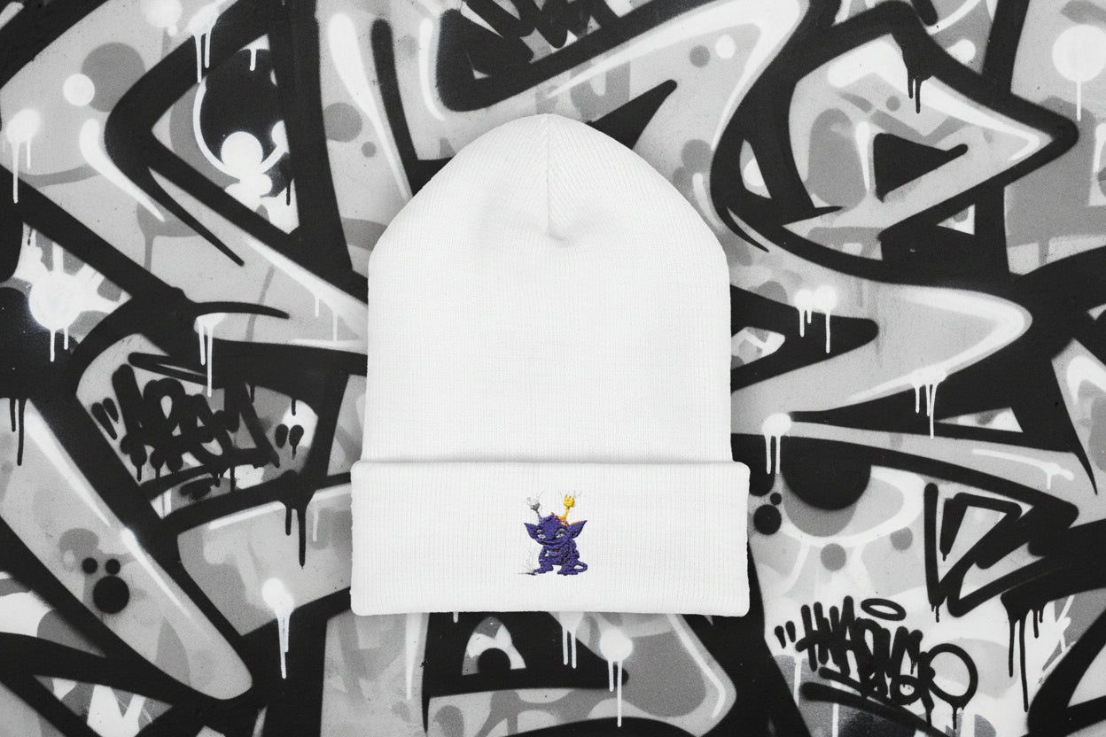 White beanie with a small embroidered design on a white background